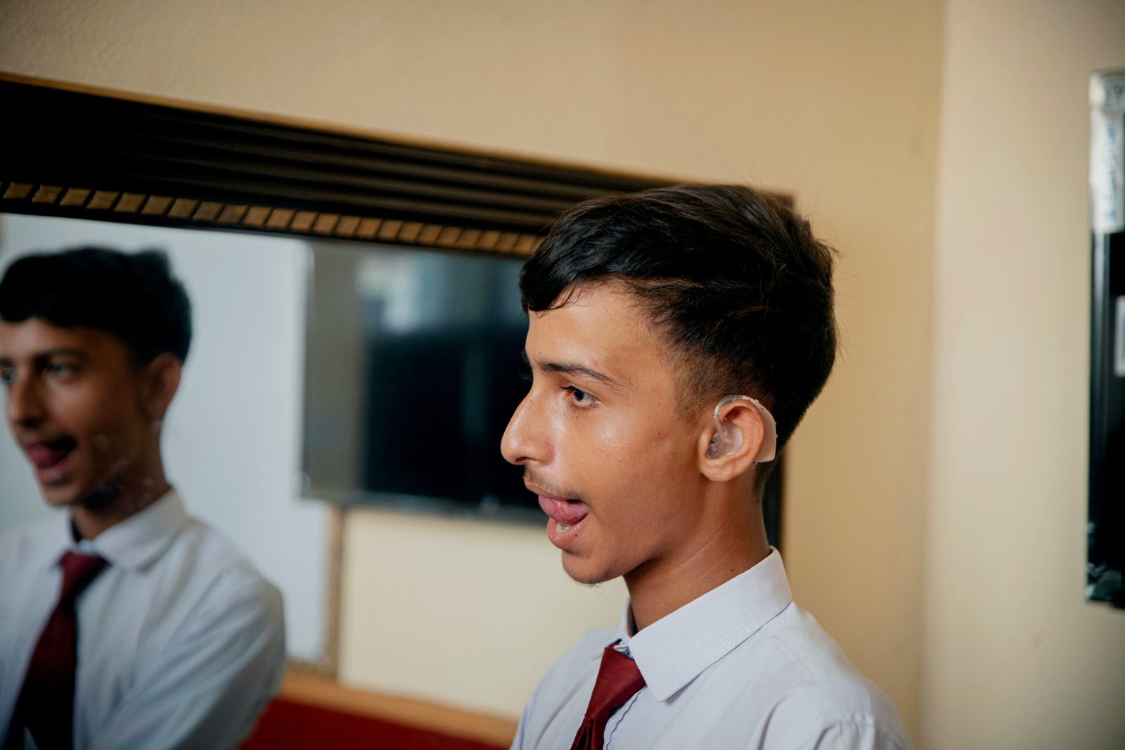 a young man in a white shirt and red tie