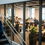 A woman takes the stairs in a modern office, incorporating healthy lifestyle changes for weight loss amidst a busy work environment.