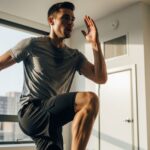 A man performing high knees indoors with dynamic energy, representing an efficient high-intensity home exercise routine.